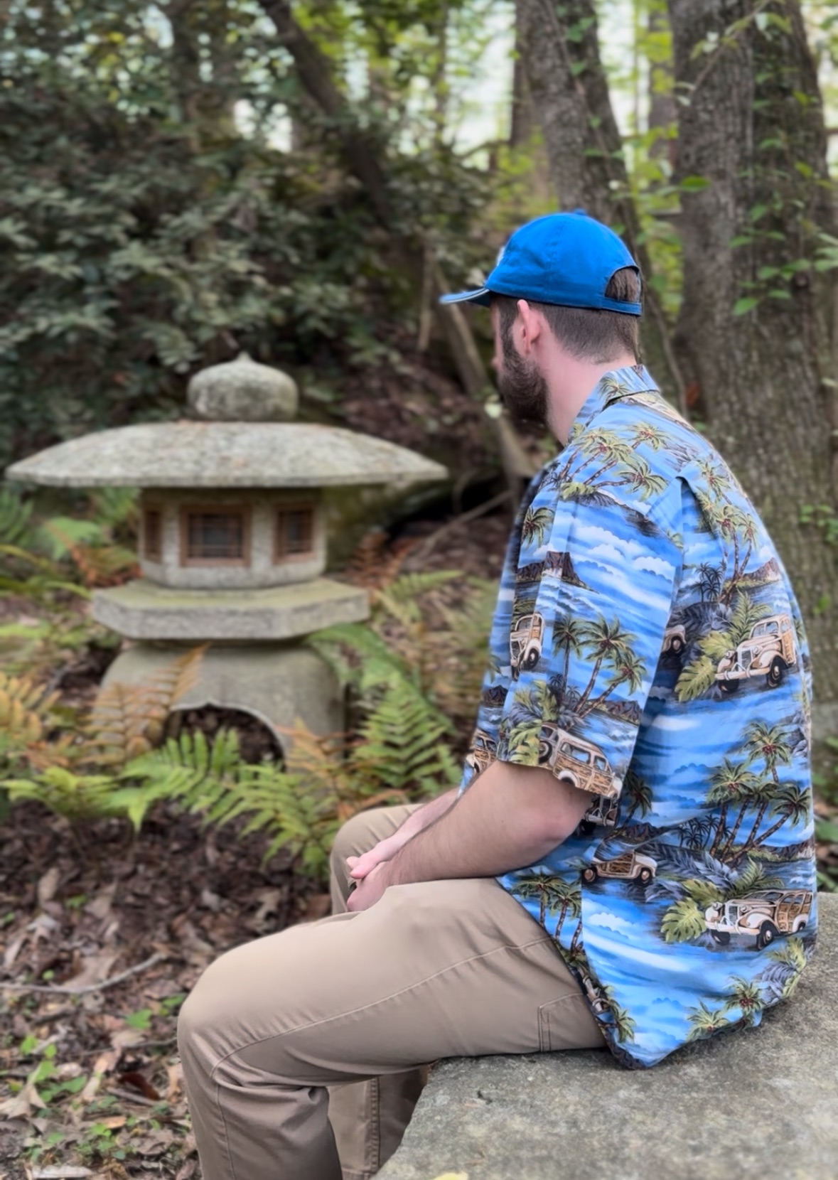 Ethan in Hawaiian shirt by Japanese stone lantern