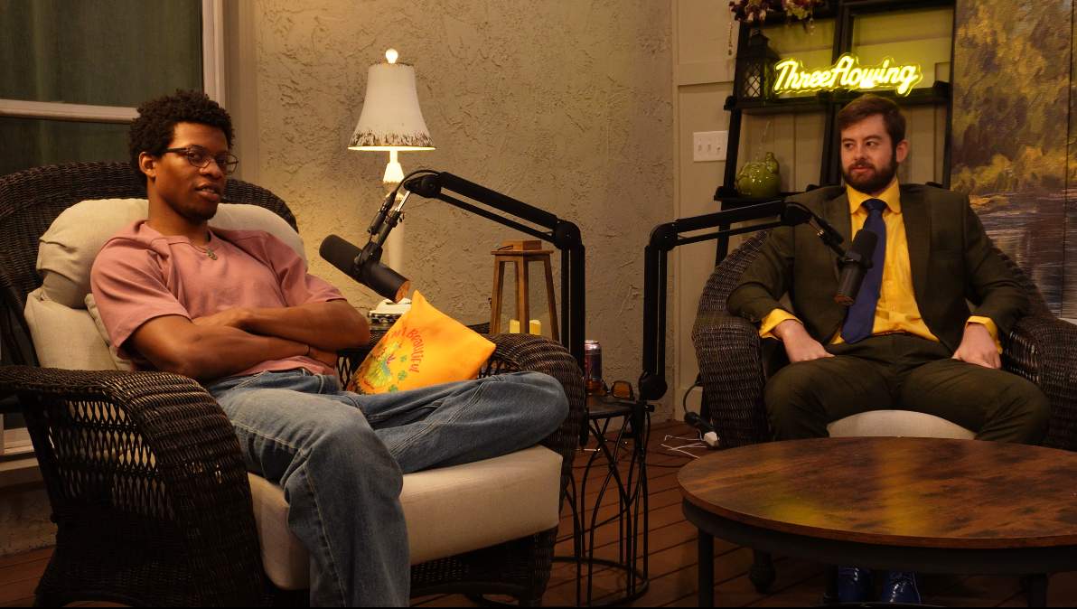 ThreeFlowing podcast hosts with a guest in a pink shirt